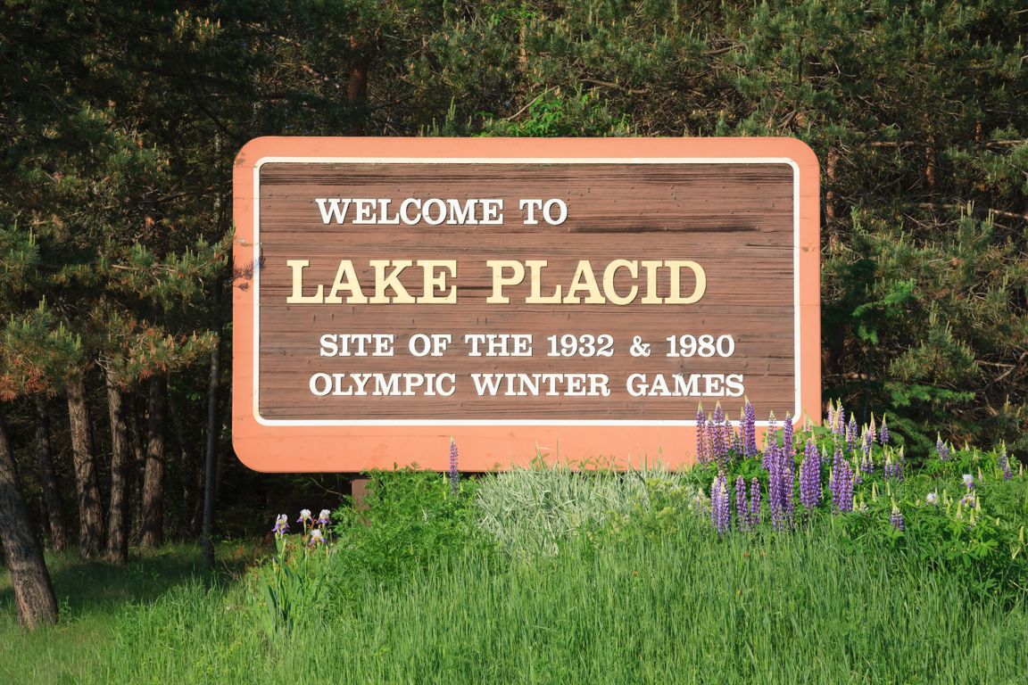 Welcome to Lake Placid highway road sign trees grass